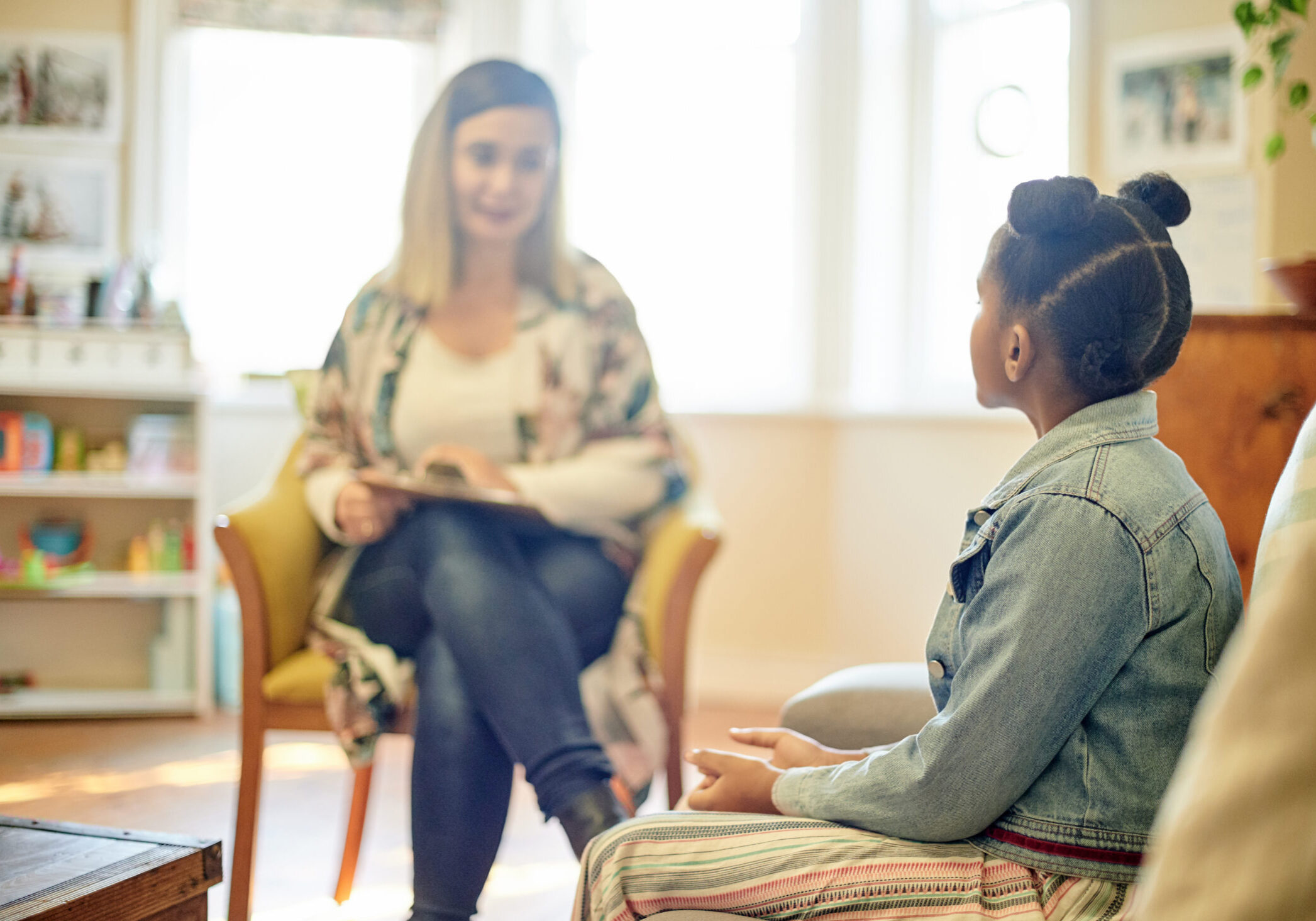 Psychologist, black girl and consultation in office for support, help or mental health. Psychology, therapist or kid or child consulting woman for counselling, therapy or talking for advice in clinic