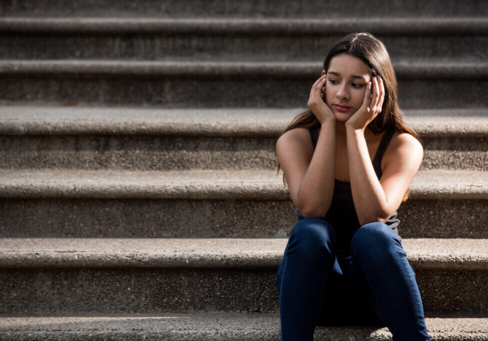 Serious teenage girl Serious teenage girl thinking and sitting on stairs